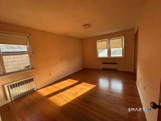 11 Edgewood Road Portland, CT 06480 - Photo 9 of 17 a view of an empty room with wooden floor and a window