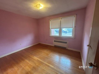11 Edgewood Road Portland, CT 06480 - Photo 10 of 17 an empty room with wooden floor and windows