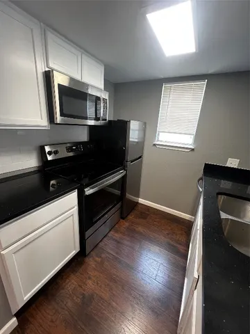 a kitchen with a refrigerator stove and microwave