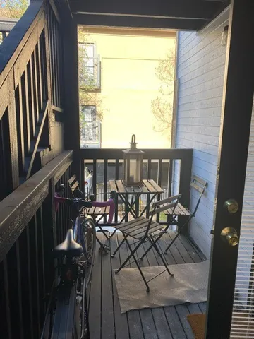 a view of a balcony dining area with furniture window