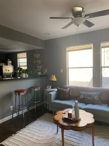 a living room with a couch and chandelier