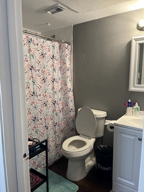 912 West 22 1/2 Street, Unit B Austin, TX 78705 - Photo 8 of 9 a white toilet sitting next to a bathroom sink