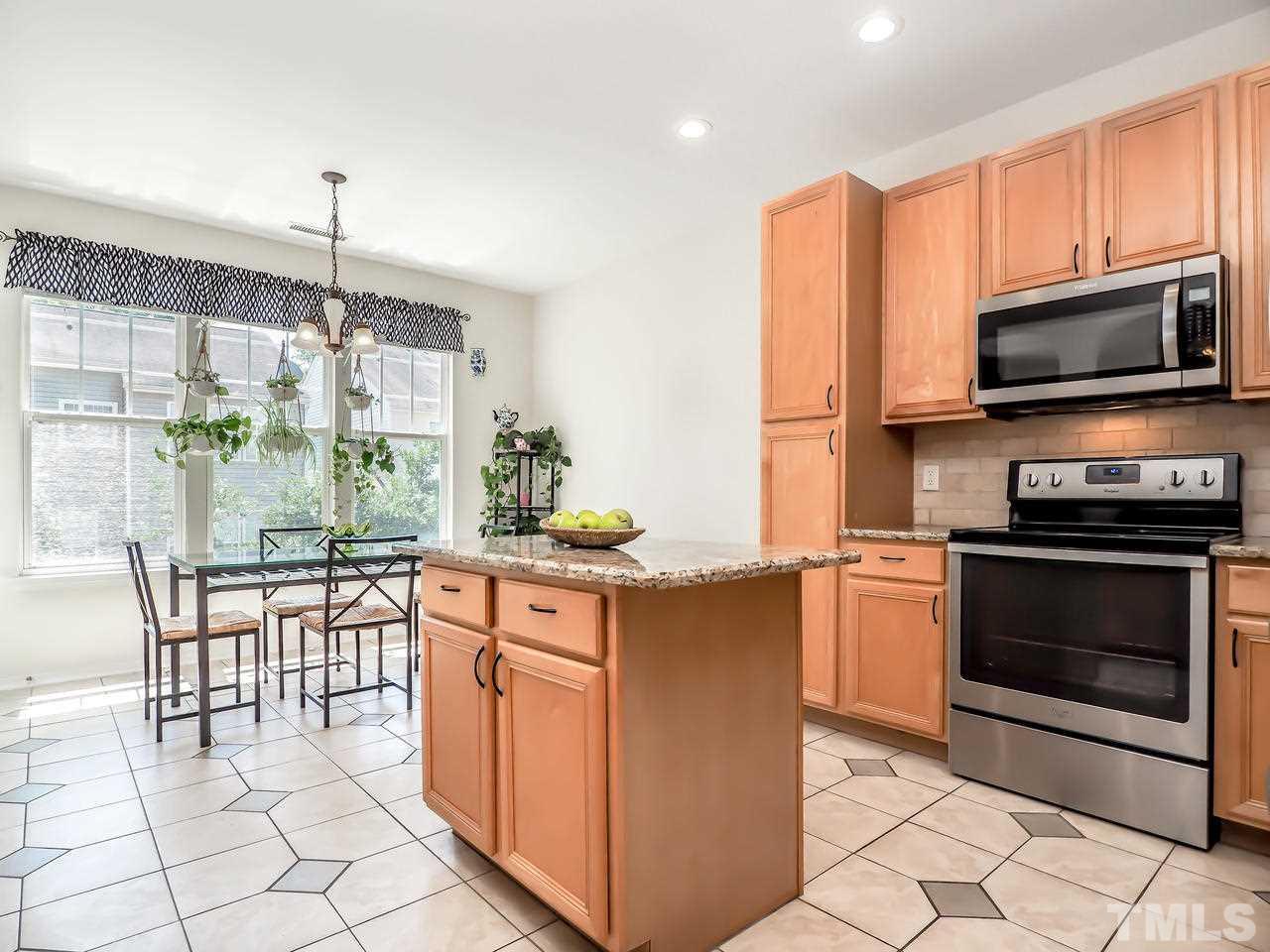 8507 Flying Buttress Drive Raleigh, NC 27613 - Photo 16 of 27 What a great working kitchen! Granite countertops, an island, stainless steel appliances and a great breakfast area with tons of natural light.