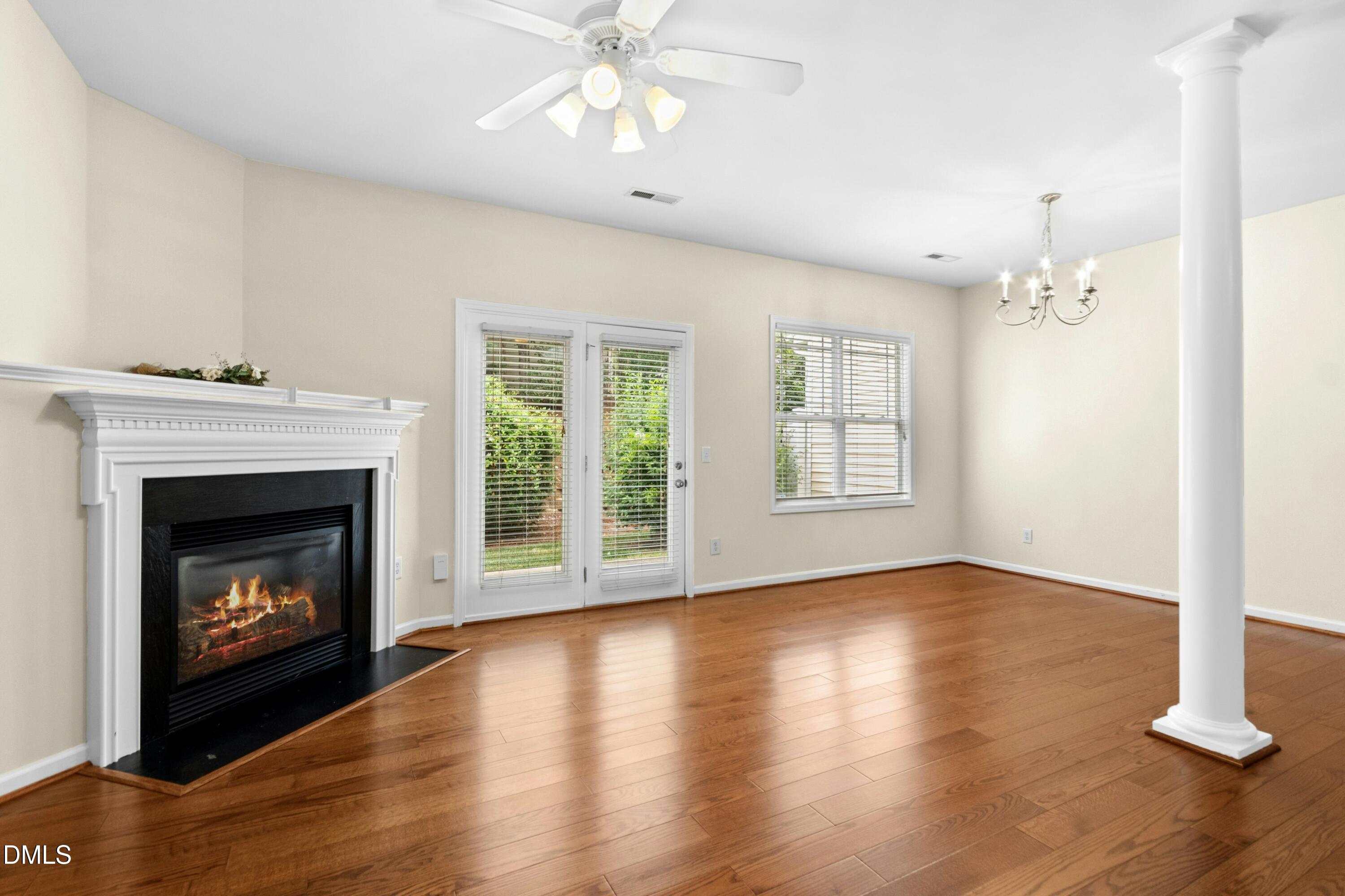 5541 Nur Lane Raleigh, NC 27606 - Photo 9 of 33 a view of an empty room with wooden floor fireplace and a window