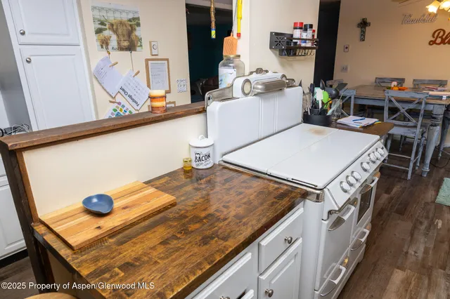 a kitchen with stainless steel appliances granite countertop a refrigerator and a stove