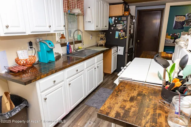 a kitchen with stainless steel appliances granite countertop a refrigerator and a stove