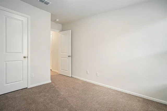 an empty room with closet area