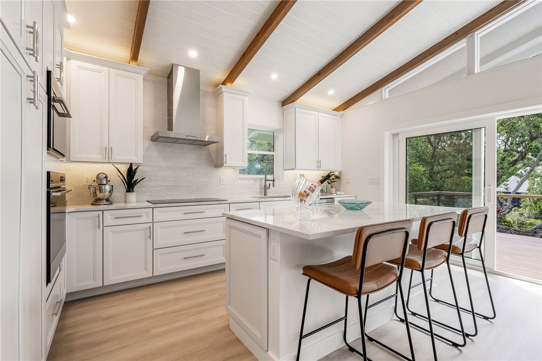 1881 Pebble Path Vero Beach, FL 32963 - Photo 13 of 34 a kitchen with stainless steel appliances kitchen island granite countertop a table chairs sink and cabinets