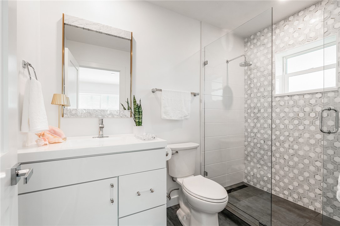 1881 Pebble Path Vero Beach, FL 32963 - Photo 26 of 34 a bathroom with a sink toilet vanity and shower