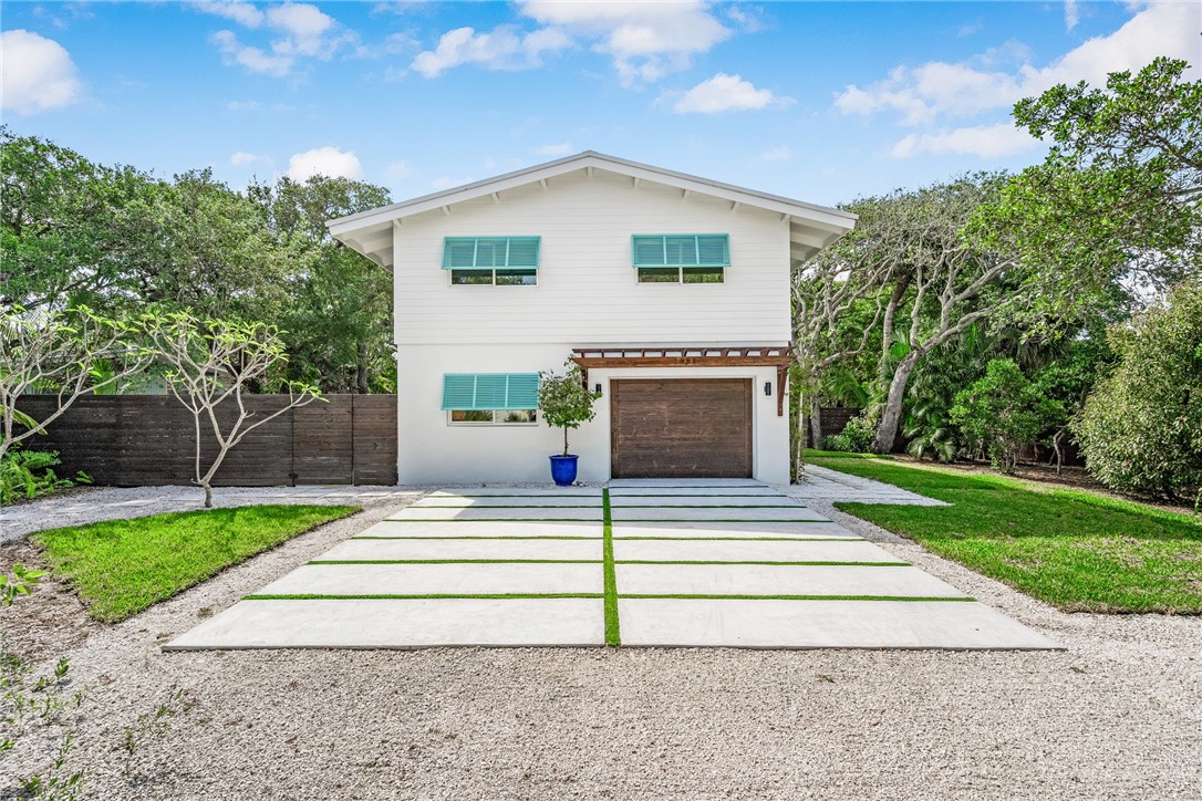 1881 Pebble Path Vero Beach, FL 32963 - Photo 34 of 34 a front view of a house with a yard and an trees