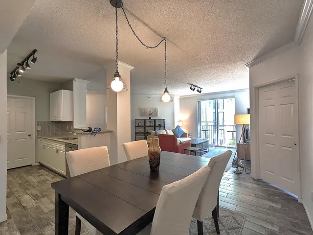 a large kitchen with a table and chairs
