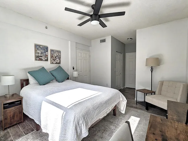 a bedroom with a bed and a chandelier