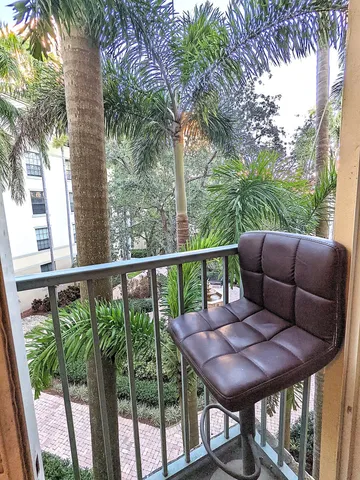 a view of a balcony with furniture