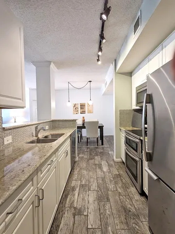 a large kitchen with a stove and a sink