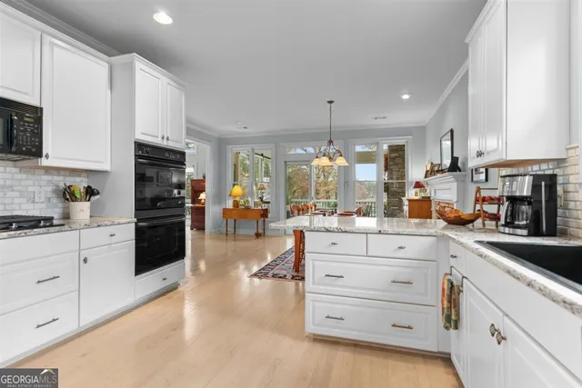 a living room with furniture a fireplace and a floor to ceiling window