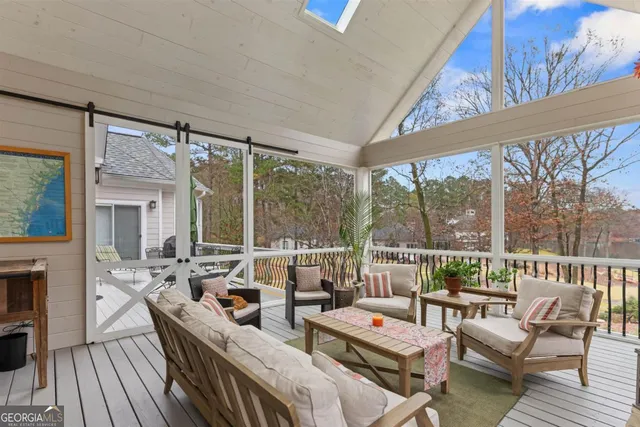 a living room with furniture a fireplace and a floor to ceiling window