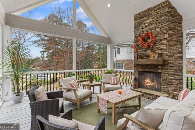 a living room with furniture fireplace and a large window