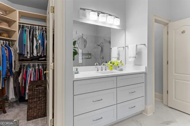 a living room with furniture a flat screen tv and kitchen view