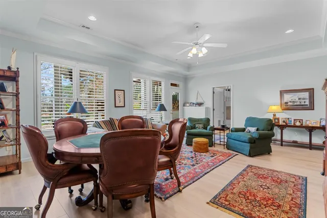 a spacious bedroom with a bed and a chandelier