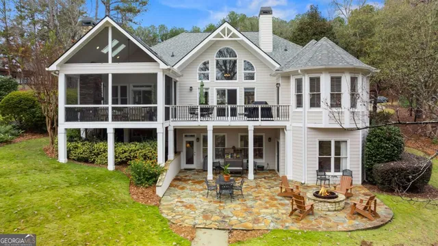 a view of a house with yard and sitting area