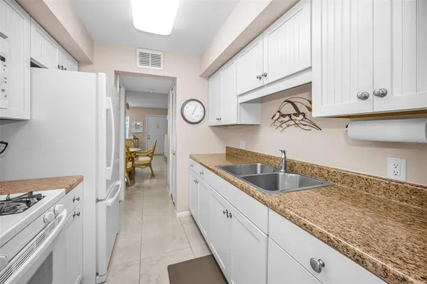a kitchen with stainless steel appliances granite countertop a sink and cabinets