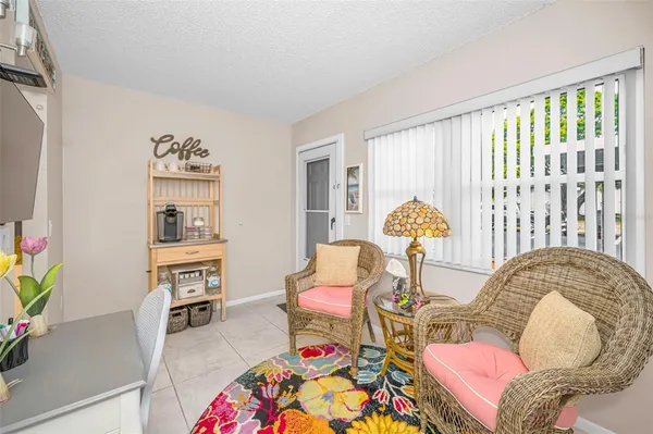 a living room with furniture a flat screen tv and a table