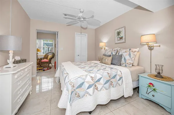 a bedroom with a large bed and a chandelier