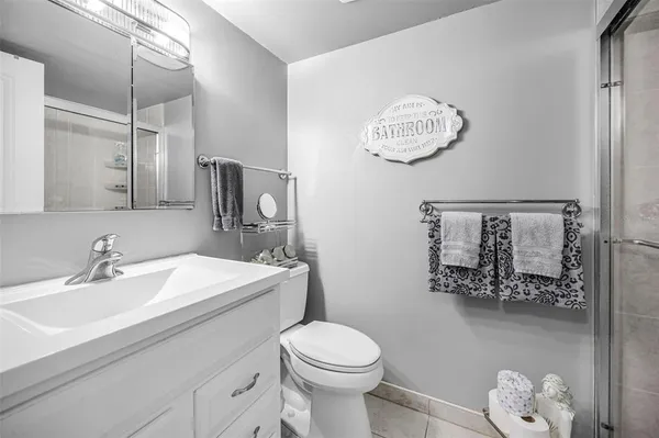 a bathroom with a glass shower door