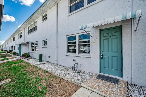 a view of a house with a wooden fence