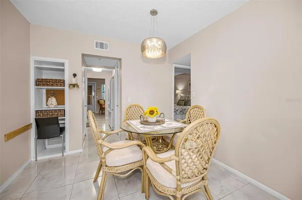 a view of a dining room with furniture and chandelier