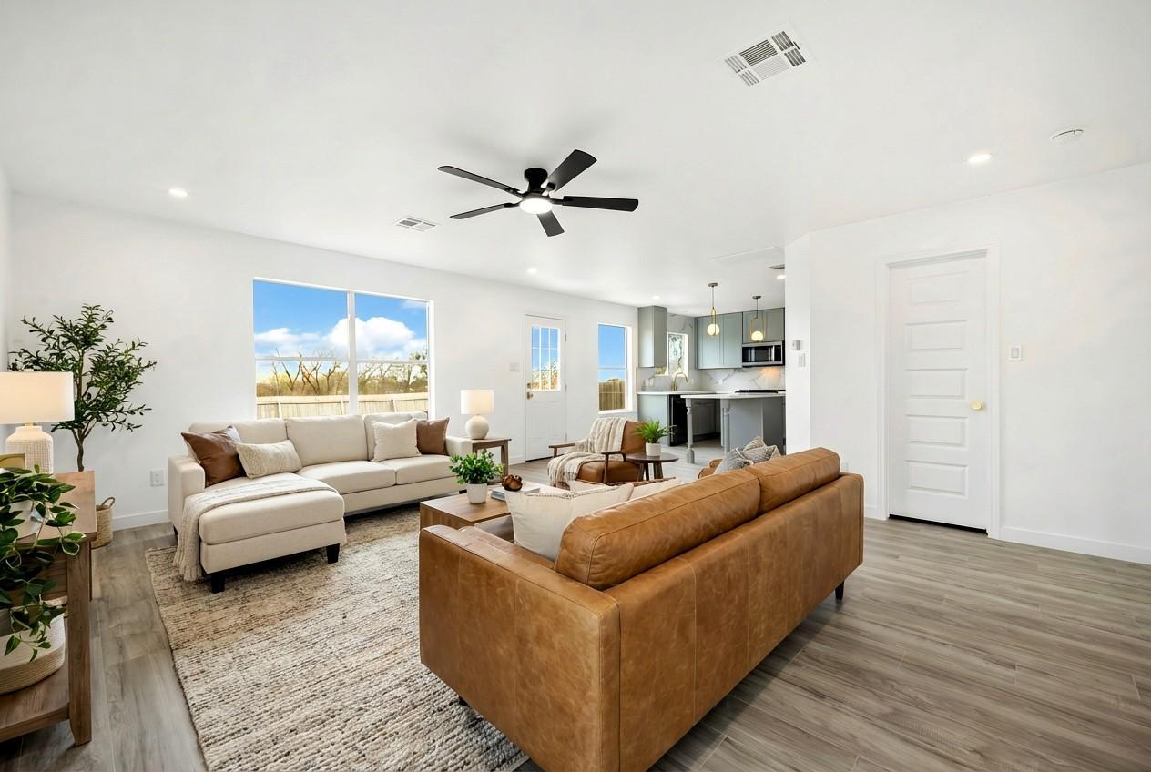 13501 Sierra Wind Lane Elgin, TX 78621 - Photo 2 of 19 Open-concept living area with wood-finish flooring, a contemporary ceiling fan, and recessed lighting