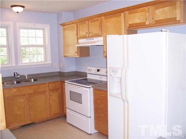 7205 Spanglers Spring Way Raleigh, NC 27610 - Photo 2 of 4 a kitchen with a sink cabinets appliances and a window