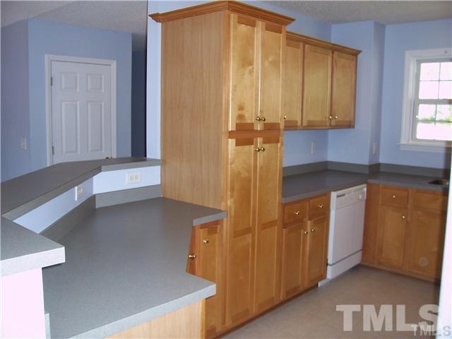 7205 Spanglers Spring Way Raleigh, NC 27610 - Photo 3 of 4 a kitchen with a refrigerator and window