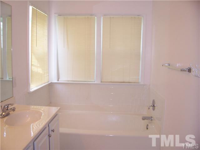 7205 Spanglers Spring Way Raleigh, NC 27610 - Photo 4 of 4 a bathroom with a bathtub and a sink