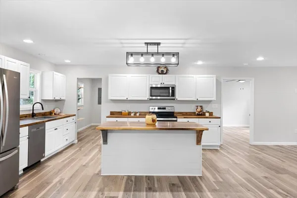 a kitchen with stainless steel appliances a stove top oven
