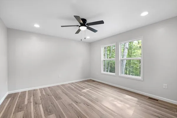 wooden floor in an empty room with a window
