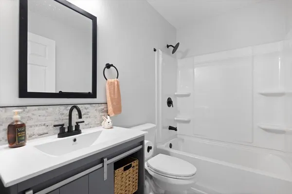 a bathroom with a sink a toilet and a mirror