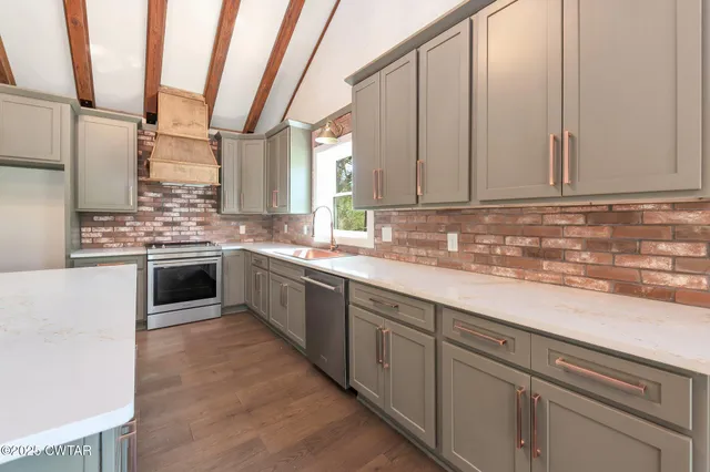 a kitchen with a stove a sink and a refrigerator