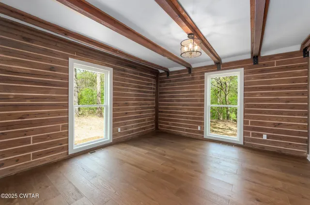 a view of a room with wooden floors and stairs