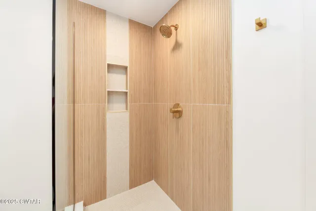 a bathroom with a sink a mirror a bathtub and vanity