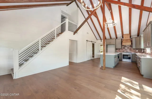 a kitchen with stainless steel appliances granite countertop a stove a sink and a window