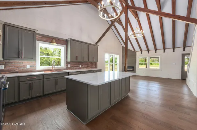 a kitchen with stainless steel appliances granite countertop a sink stove and cabinets