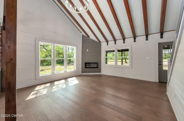 a view of a livingroom with furniture window and wooden floor