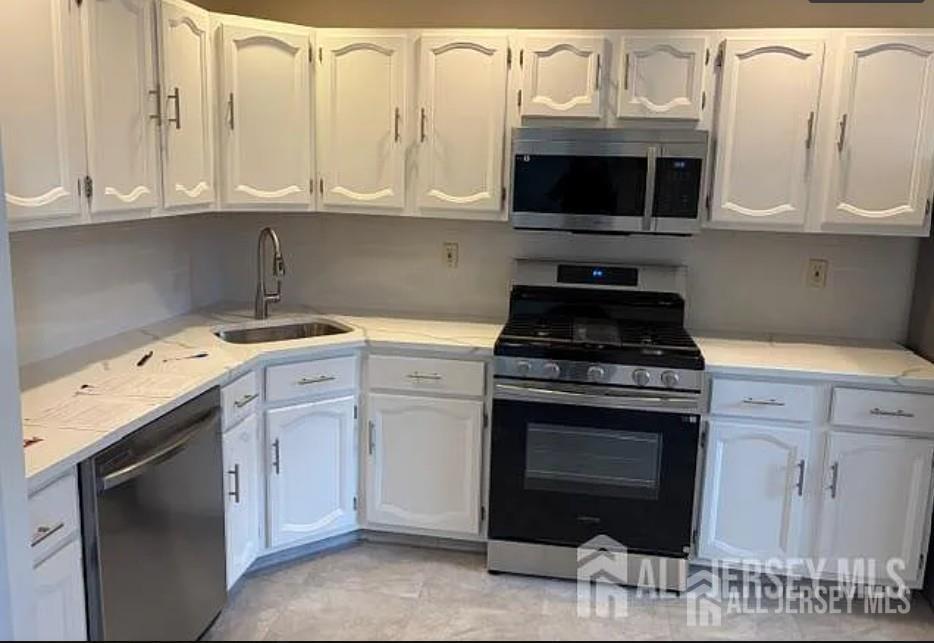 31 Gate House Lane Edison, NJ 08820 - Photo 10 of 15 a kitchen with stainless steel appliances granite countertop a stove and a microwave