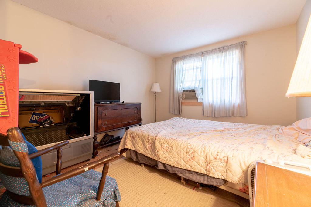 44 Deerfield Road Mashpee, MA 02649 - Photo 11 of 17 a bedroom with a bed and a tv on the dresser