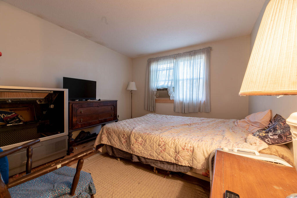 44 Deerfield Road Mashpee, MA 02649 - Photo 12 of 17 a bedroom with a bed and a tv on the dresser