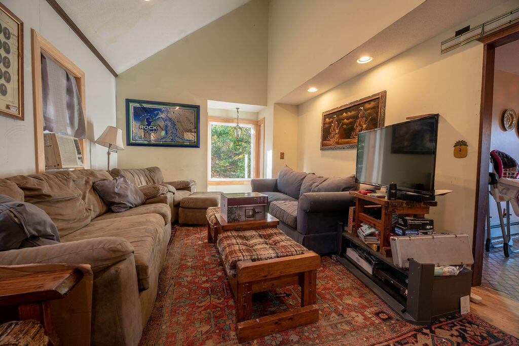 44 Deerfield Road Mashpee, MA 02649 - Photo 4 of 17 a living room with furniture a flat screen tv and a window