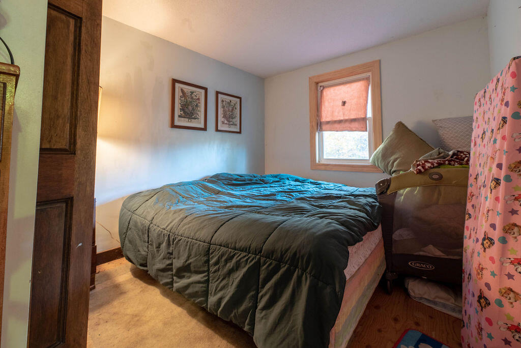 44 Deerfield Road Mashpee, MA 02649 - Photo 8 of 17 a bed sitting in a bedroom next to a window