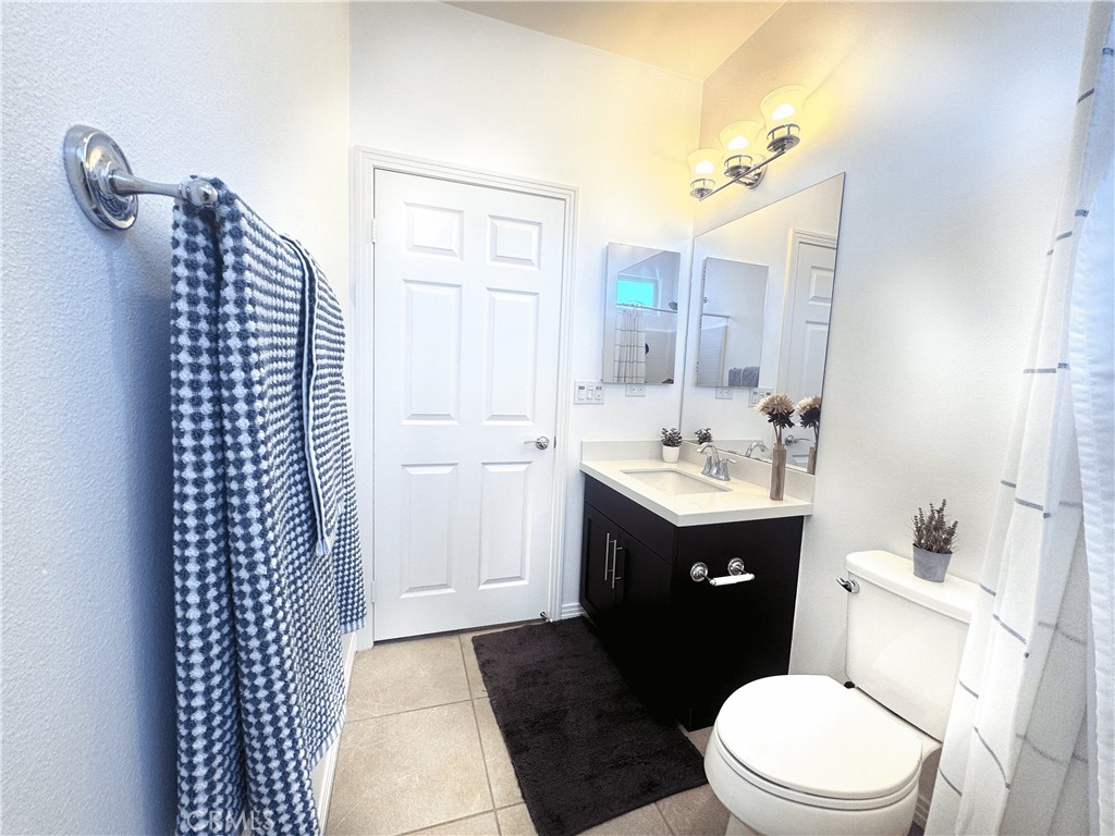 39995 Alba Way Palm Desert, CA 92211 - Photo 22 of 44 a bathroom with a sink a toilet a mirror and shower