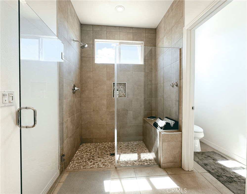 39995 Alba Way Palm Desert, CA 92211 - Photo 28 of 44 a bathroom with a granite countertop shower and a toilet